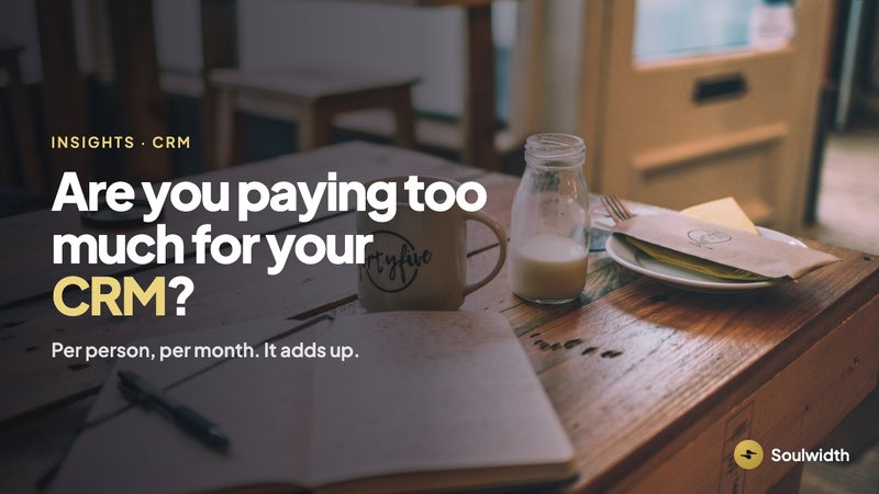 Are you paying too much for your CRM? A notebook and coffee on a cafe table